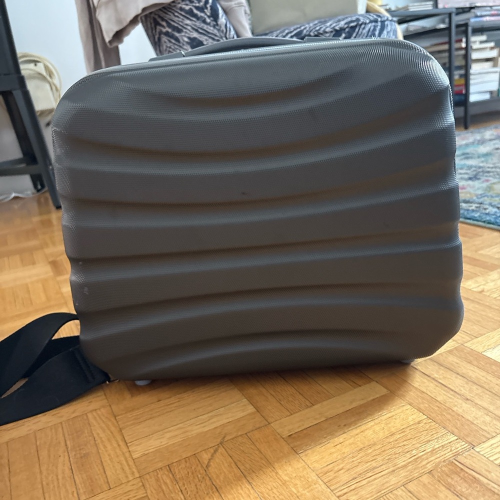 Gray hard sided carry-on bag